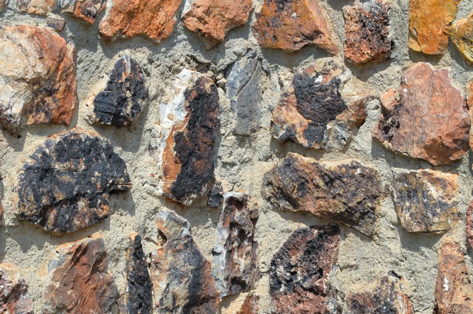 A knapped flint and stone wall in warm light
