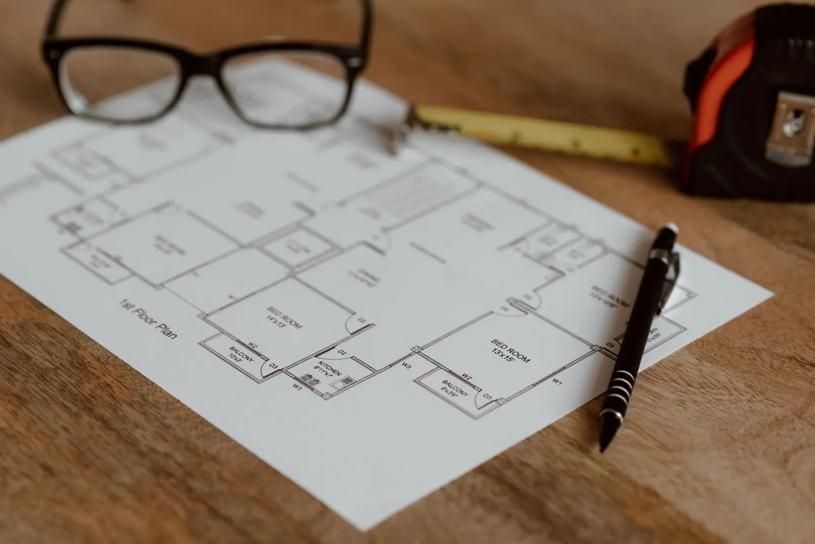 A measured floor plan on the studio table
